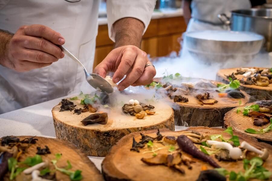 Mushrooms served on sections of tree trunks as plate - interesting cuisine.